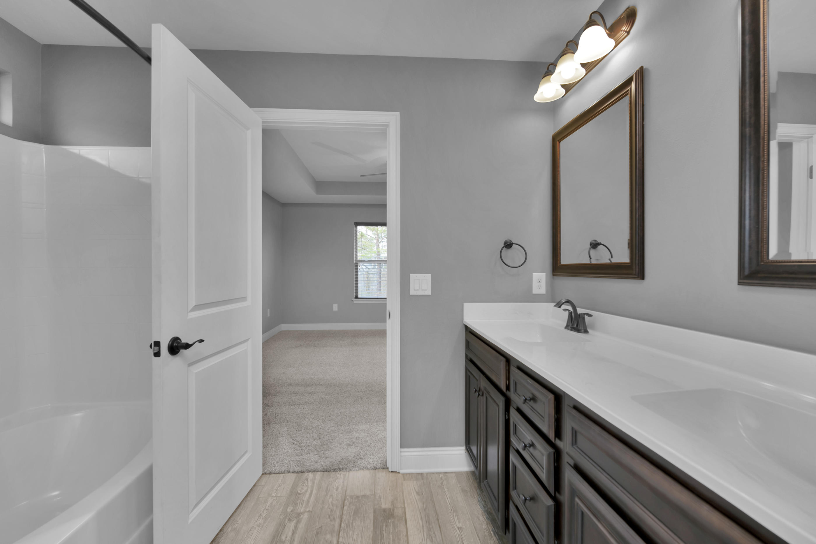 2047 Alhambra Street Navarre, FL 32566 - Photo 14 of 24 a bathroom with a double vanity sink a mirror and a shower