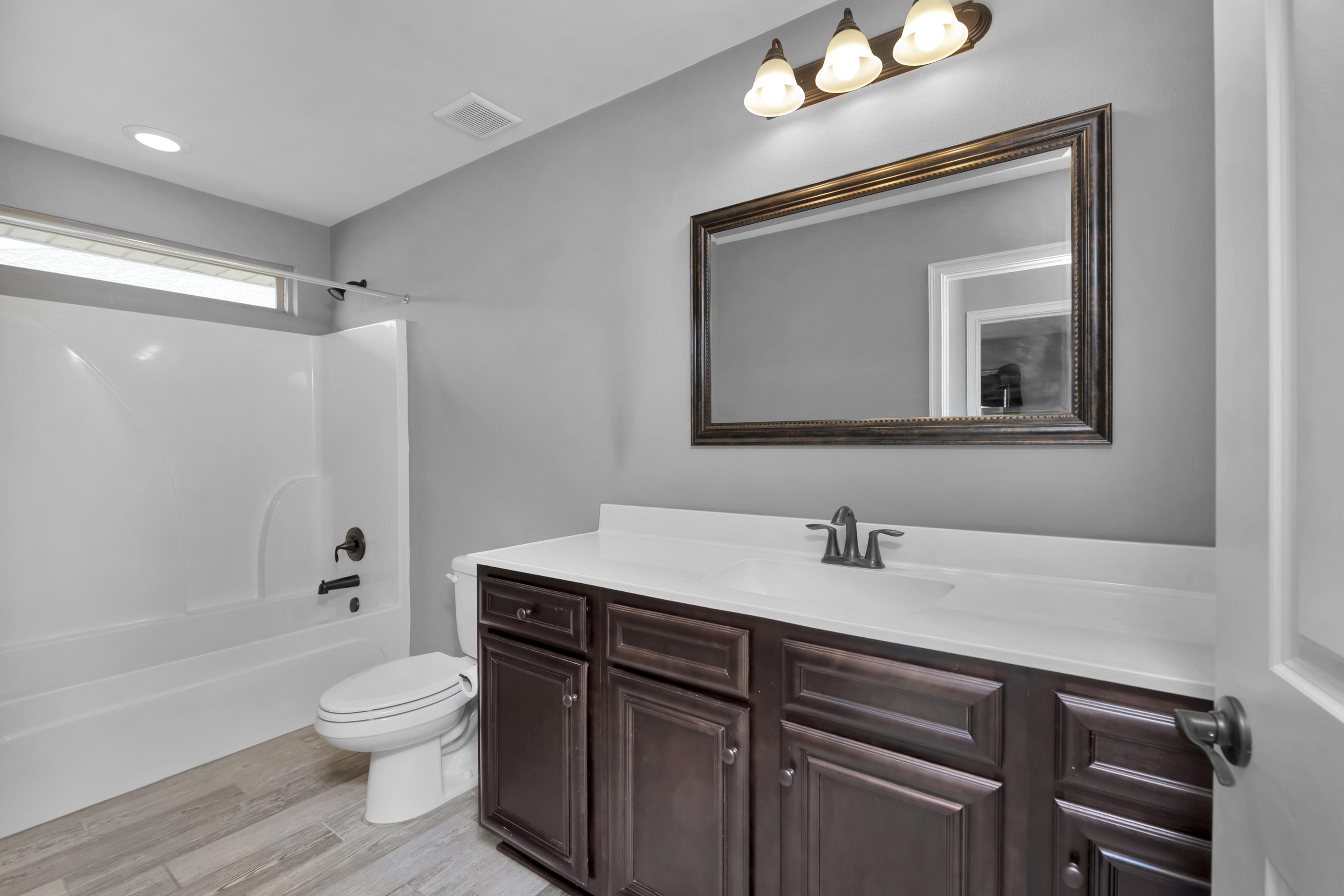 2047 Alhambra Street Navarre, FL 32566 - Photo 15 of 24 a bathroom with a toilet sink and mirror