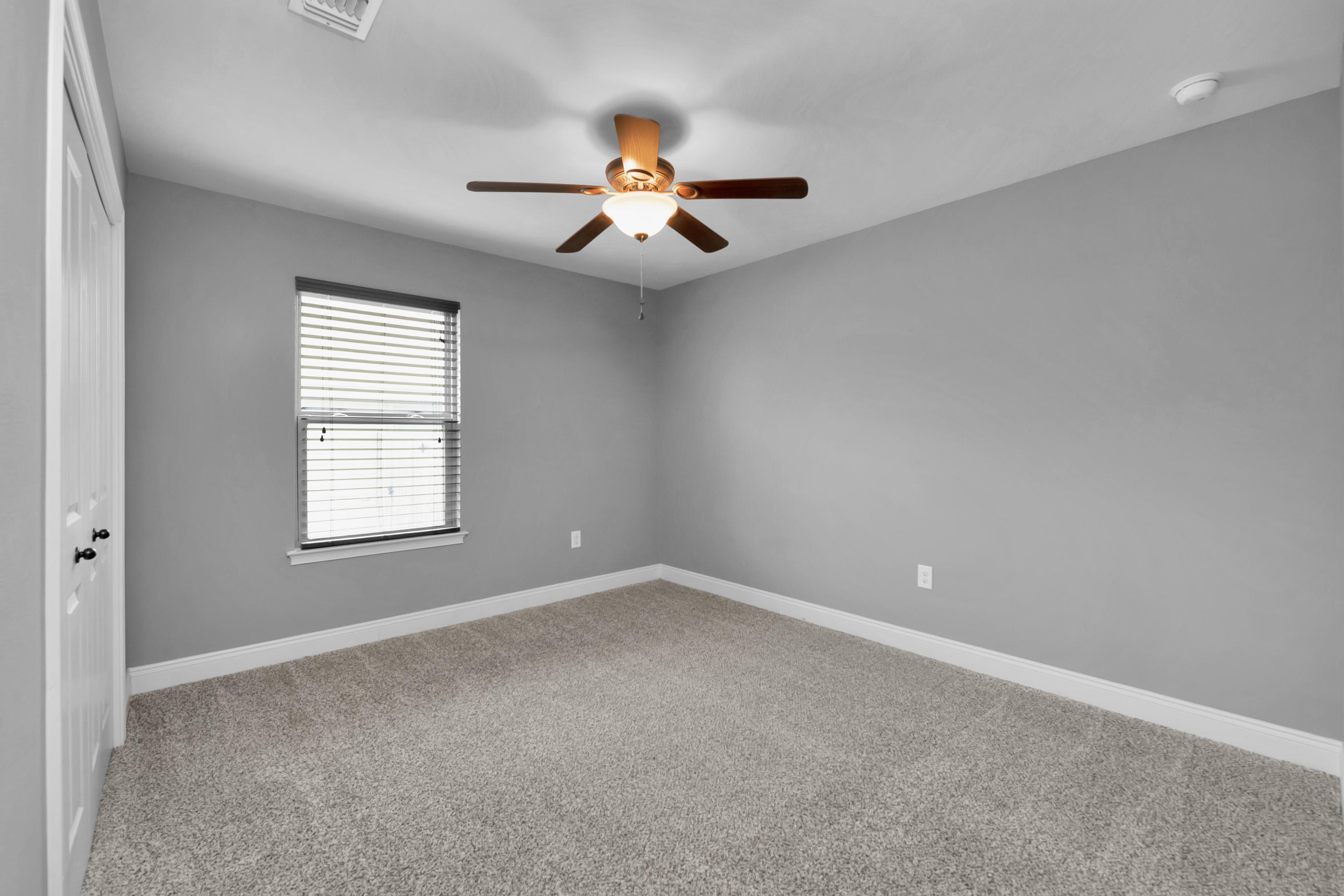 2047 Alhambra Street Navarre, FL 32566 - Photo 18 of 24 an empty room with windows and chandelier fan