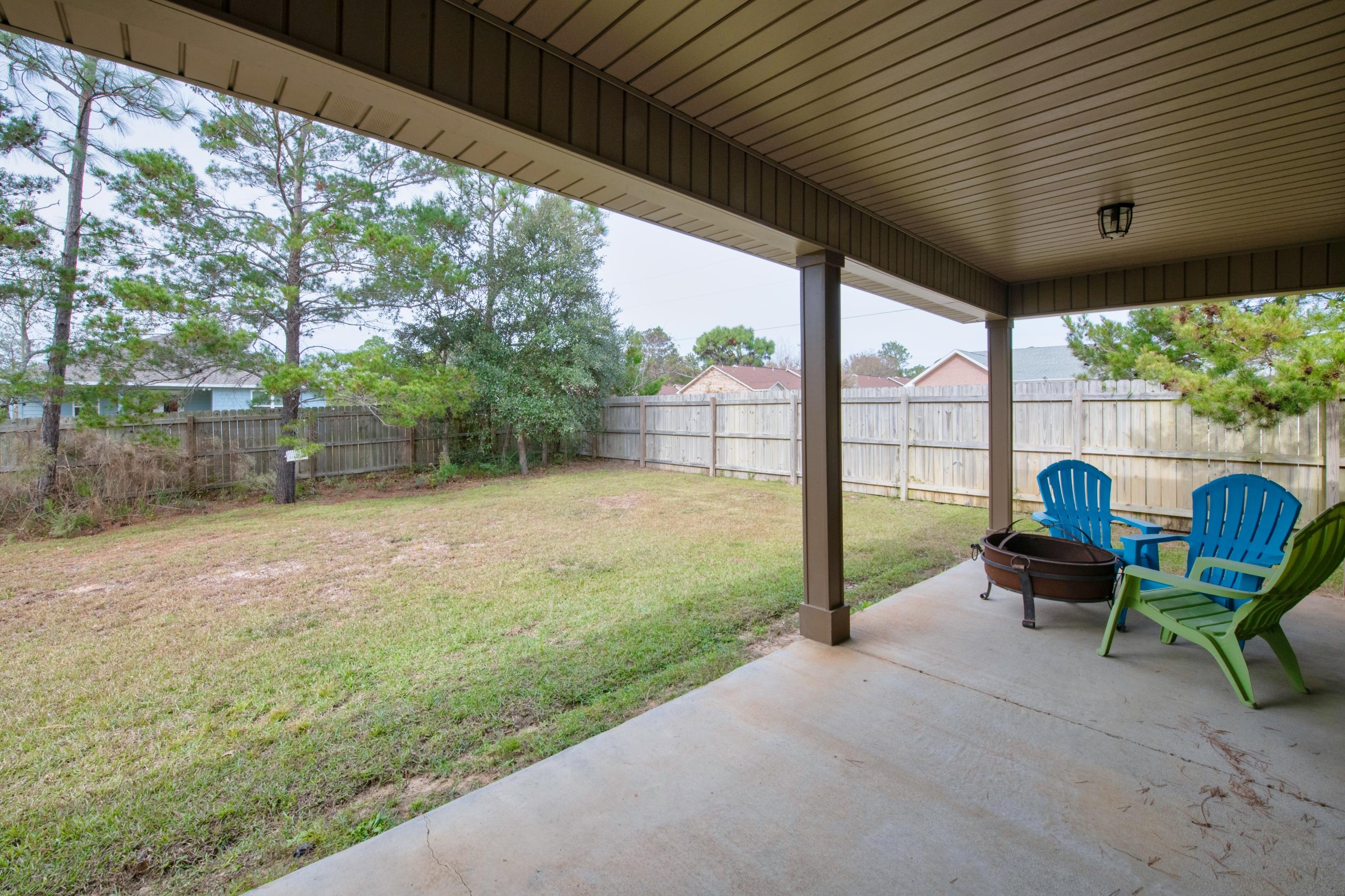 2047 Alhambra Street Navarre, FL 32566 - Photo 20 of 24 a view of a porch with furniture and garden