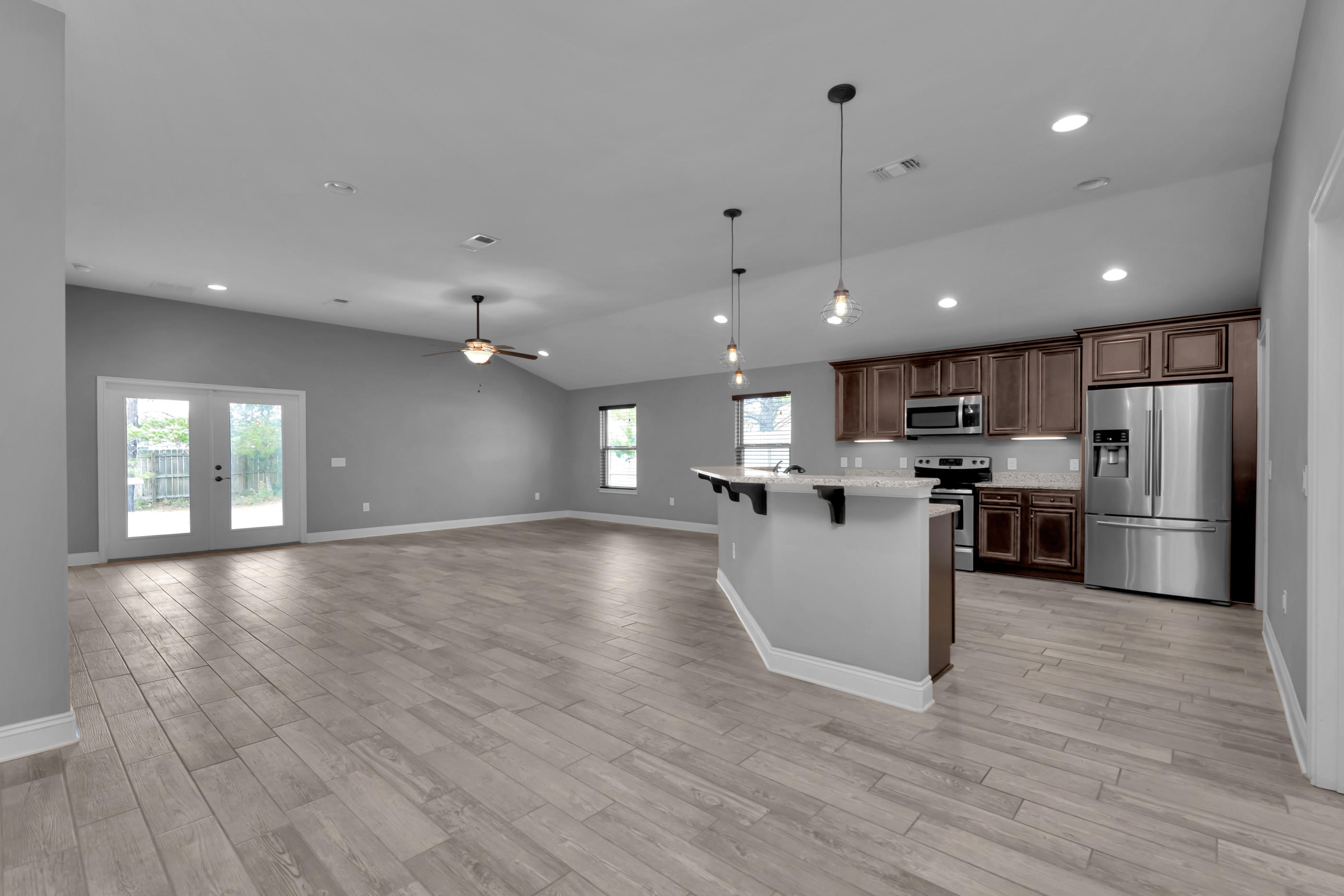 2047 Alhambra Street Navarre, FL 32566 - Photo 4 of 24 a view of kitchen with refrigerator stove and wooden floor