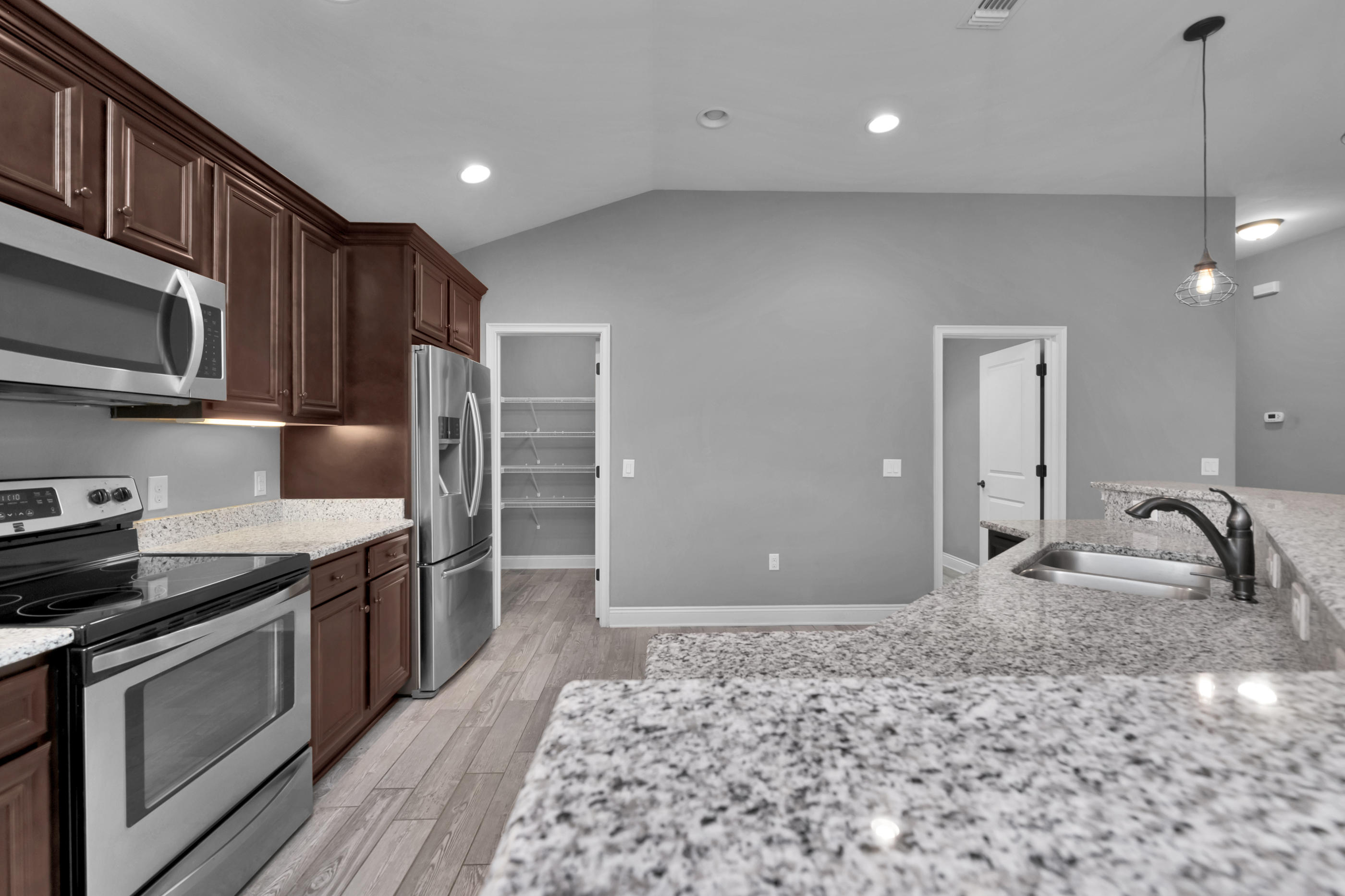 2047 Alhambra Street Navarre, FL 32566 - Photo 8 of 24 a kitchen with stainless steel appliances granite countertop a stove a sink and a microwave