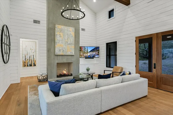 a living room with furniture a fireplace and wooden floor