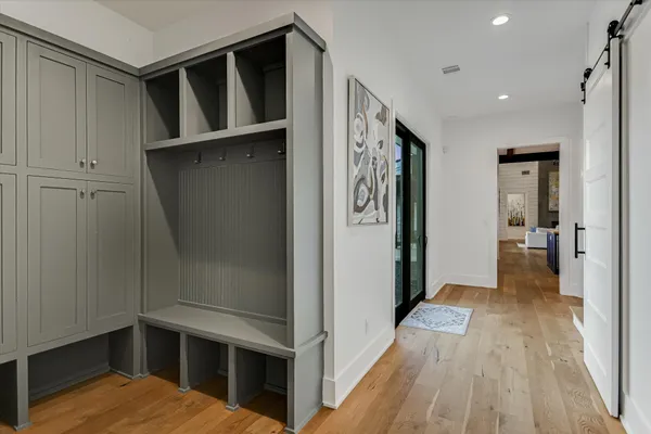 a view of walk in closet with wooden floor