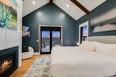 a bedroom with a bed and a flat screen tv