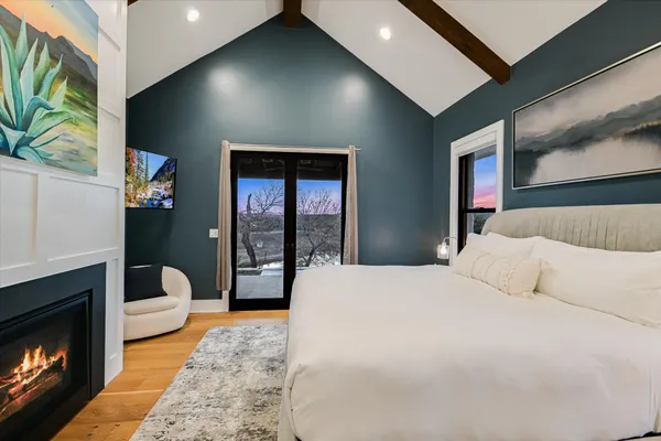 a bedroom with a bed and a flat screen tv