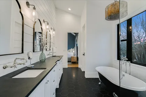 a bathroom with a double vanity sink and mirror