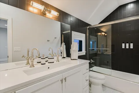 a bathroom with a sink double vanity and a toilet