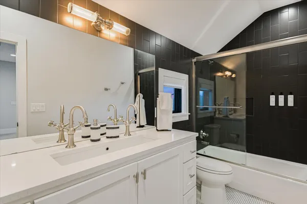 a bathroom with a sink double vanity and a toilet