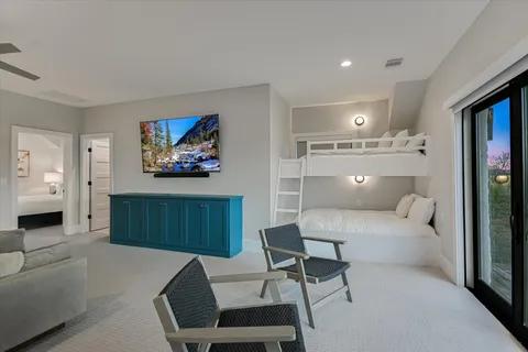 a living room with furniture and a floor to ceiling window