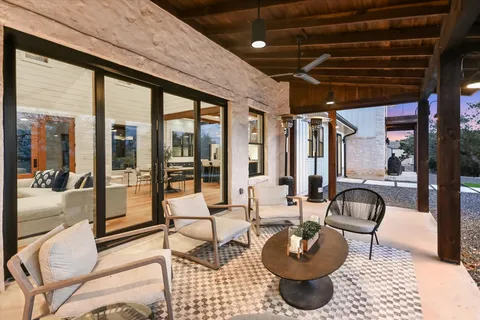 a living room with patio furniture and a fireplace