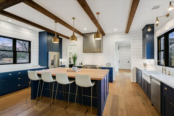 a large kitchen with a table and chairs