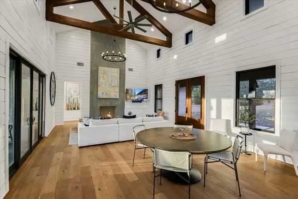 a living room with fireplace furniture and a table