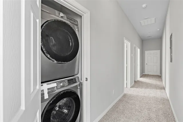 a view of a hallway with washer and dryer