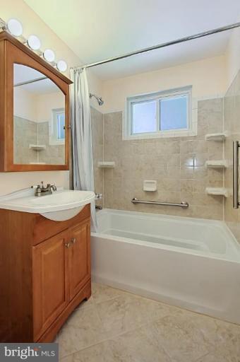 8615 Victoria Road Springfield, VA 22151 - Photo 22 of 30 a bathroom with a tub sink and mirror