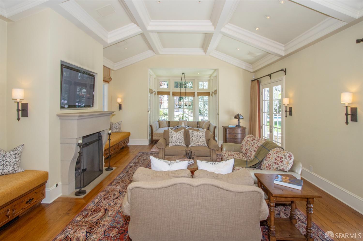 75 Almendral Avenue Atherton, CA 94027 - Photo 25 of 40 a living room with fireplace furniture and a chandelier