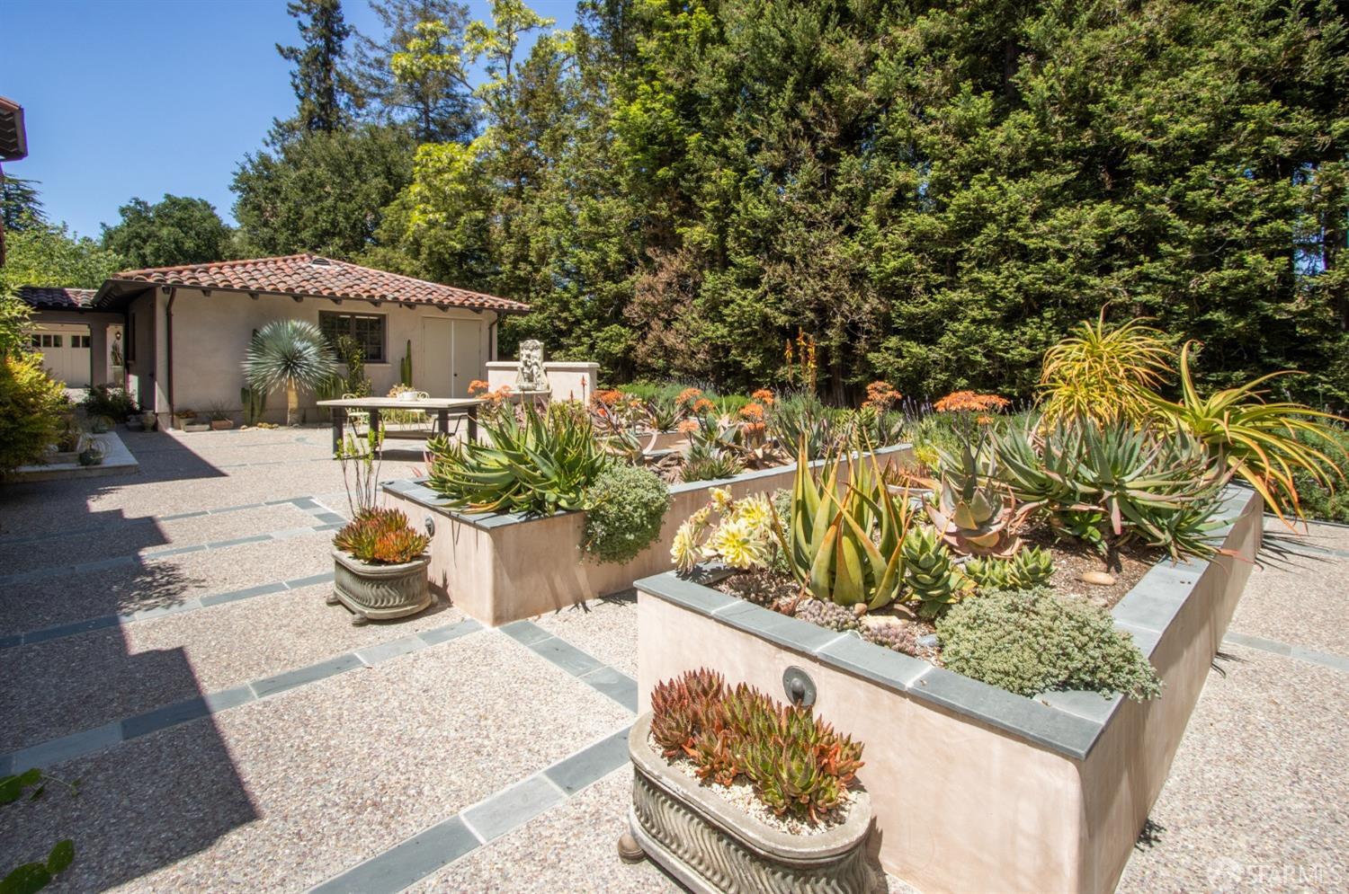 75 Almendral Avenue Atherton, CA 94027 - Photo 30 of 40 a view of a patio with table and chairs potted plants with wooden fence