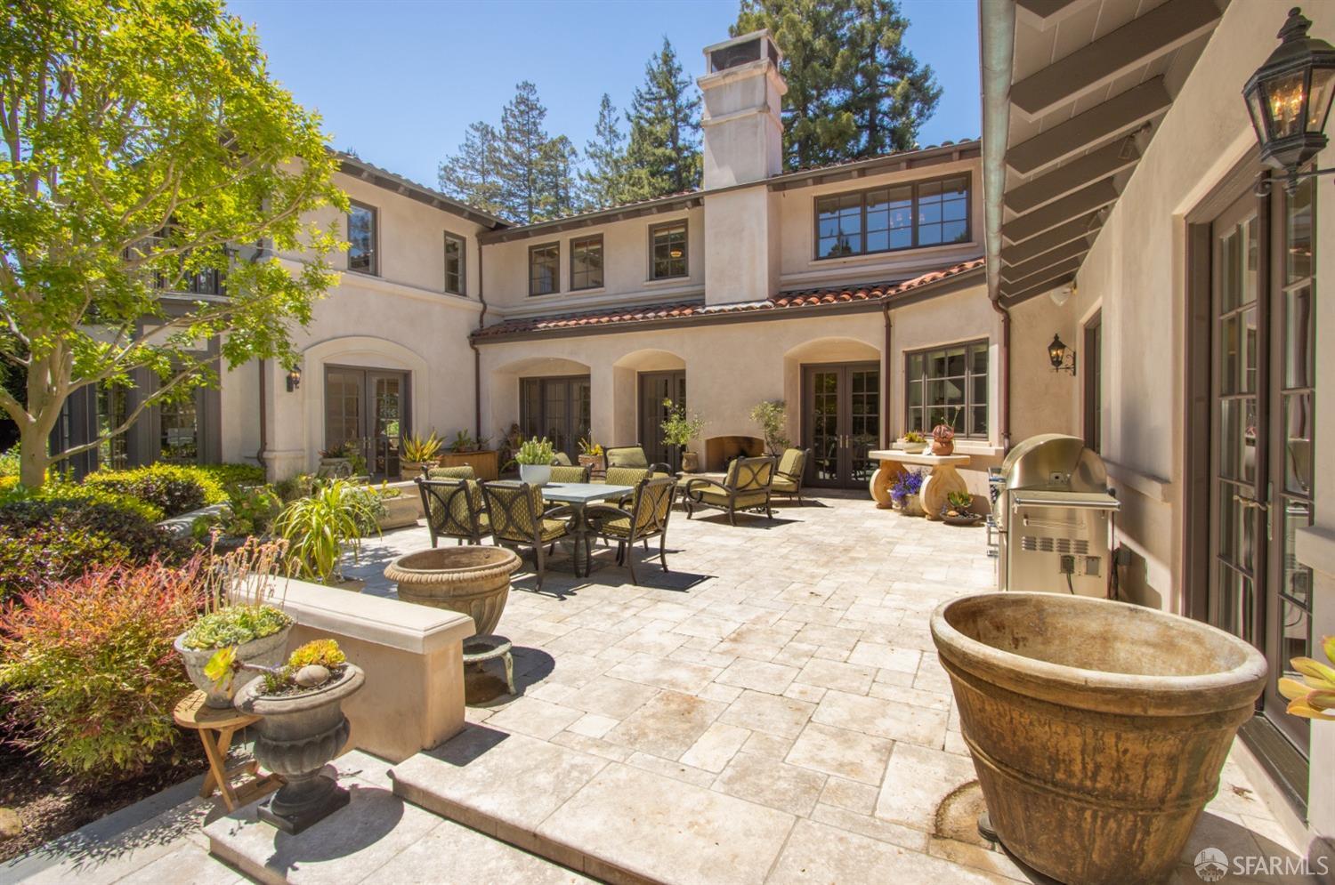 75 Almendral Avenue Atherton, CA 94027 - Photo 31 of 40 a view of a patio with couches table and chairs and potted plants