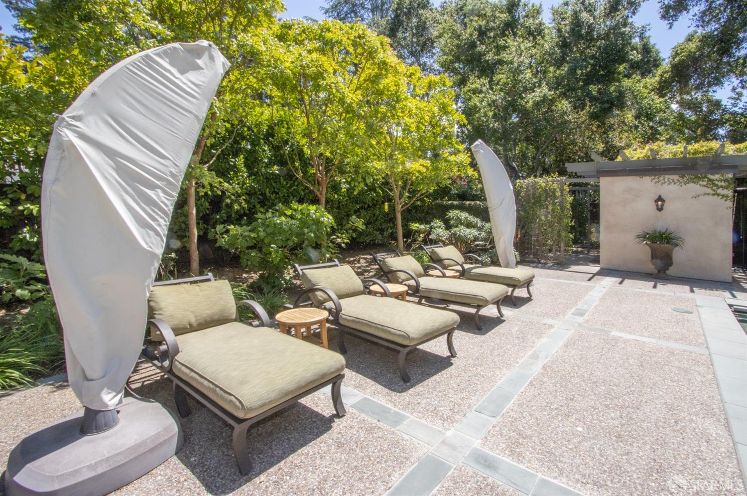 75 Almendral Avenue Atherton, CA 94027 - Photo 36 of 40 a view of a patio with couches and a table and chairs with wooden floor and fence