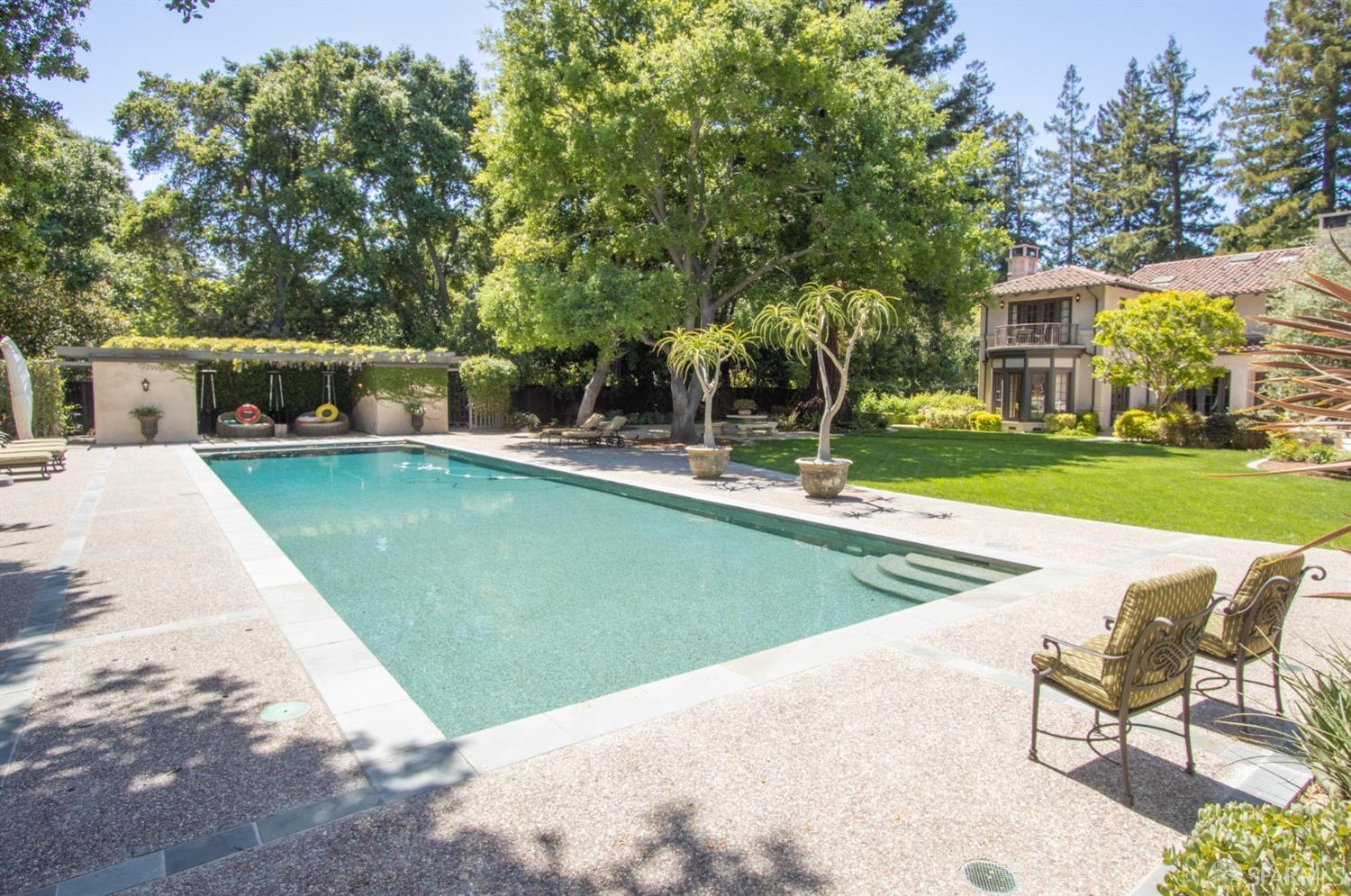 75 Almendral Avenue Atherton, CA 94027 - Photo 39 of 40 a view of a swimming pool with lawn chairs and plants