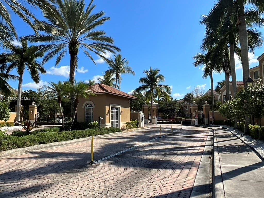 7940 North Nob Hill Road, Unit 201 Tamarac, FL 33321 - Photo 2 of 10 a front view of a house with palm trees