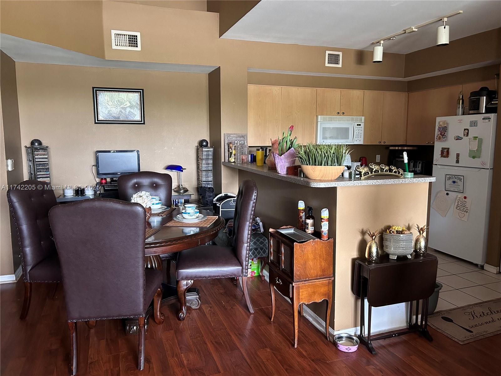 7940 North Nob Hill Road, Unit 201 Tamarac, FL 33321 - Photo 5 of 10 a dining room with furniture and wooden floor