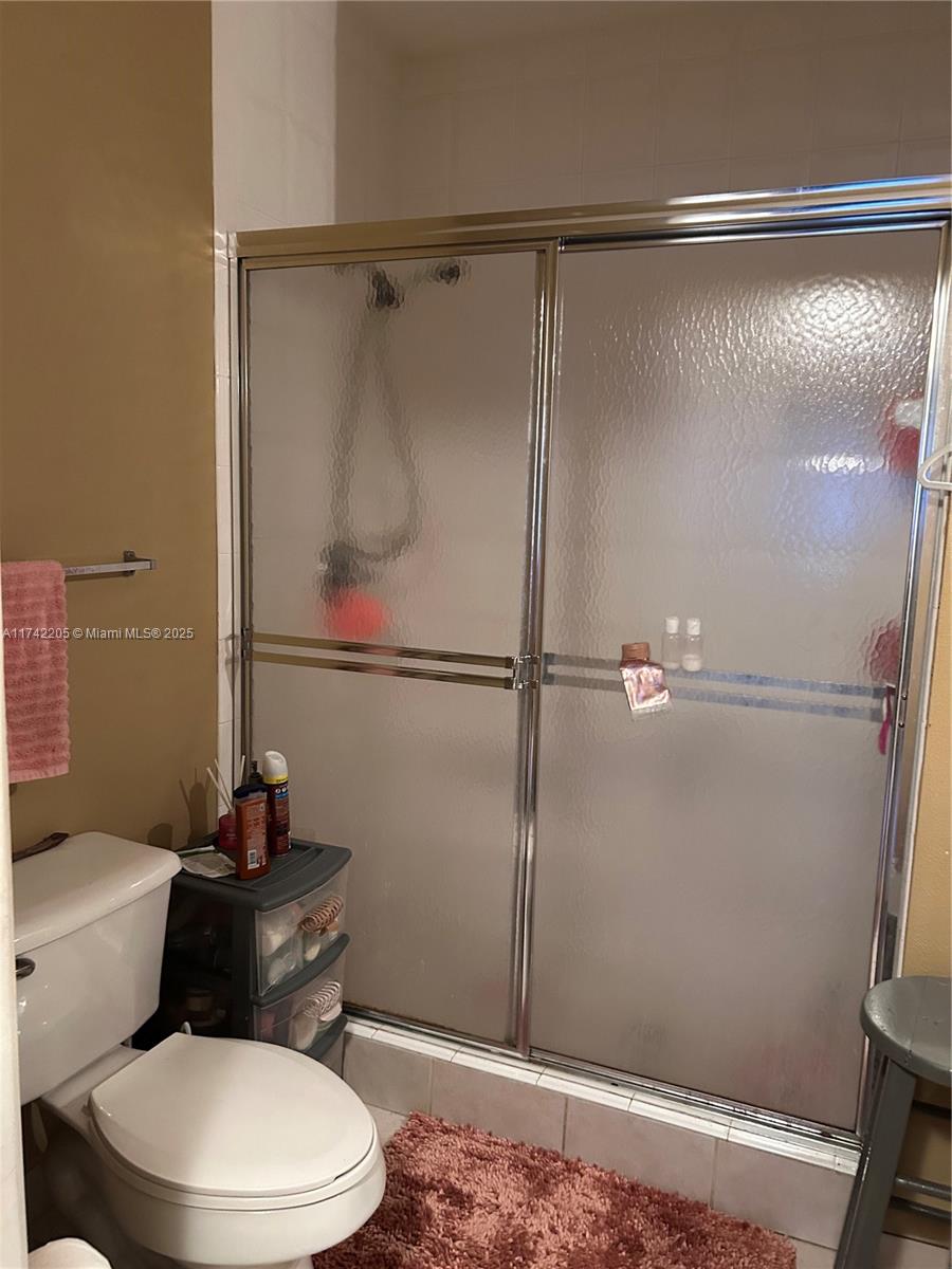 7940 North Nob Hill Road, Unit 201 Tamarac, FL 33321 - Photo 7 of 10 a bathroom with a toilet and a shower