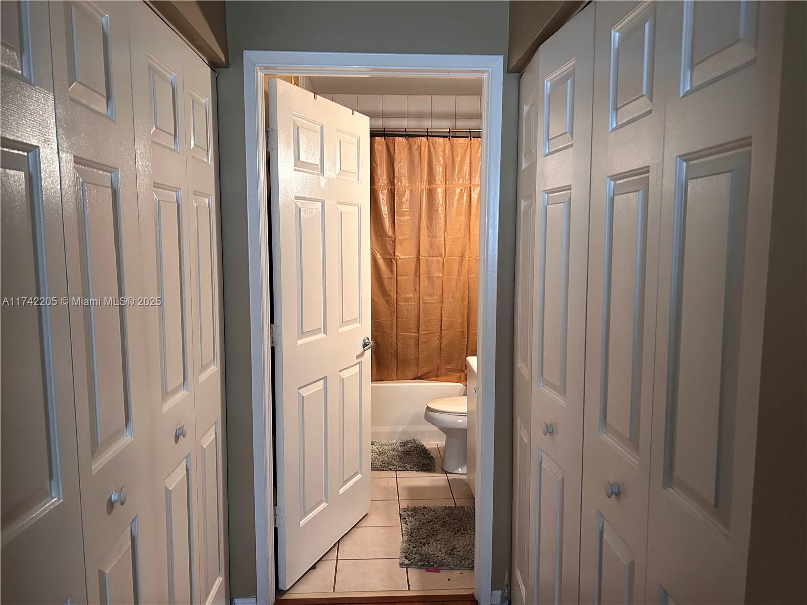 7940 North Nob Hill Road, Unit 201 Tamarac, FL 33321 - Photo 9 of 10 a view of a bathroom from a hallway