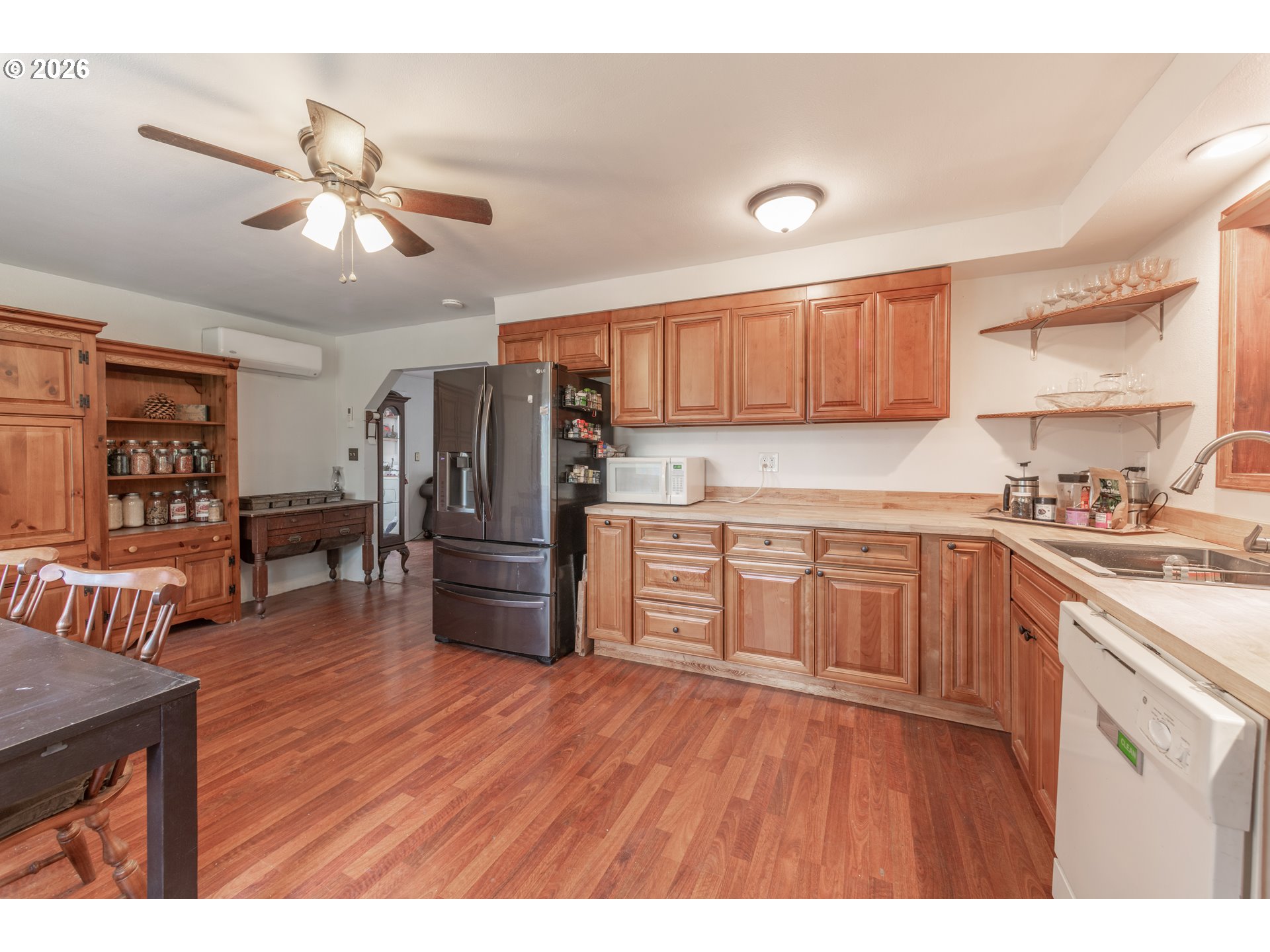 60045 Northwest Railroad Avenue Timber, OR 97144 - Photo 11 of 41 a kitchen with stainless steel appliances granite countertop a refrigerator a sink dishwasher a stove with wooden cabinets and floor