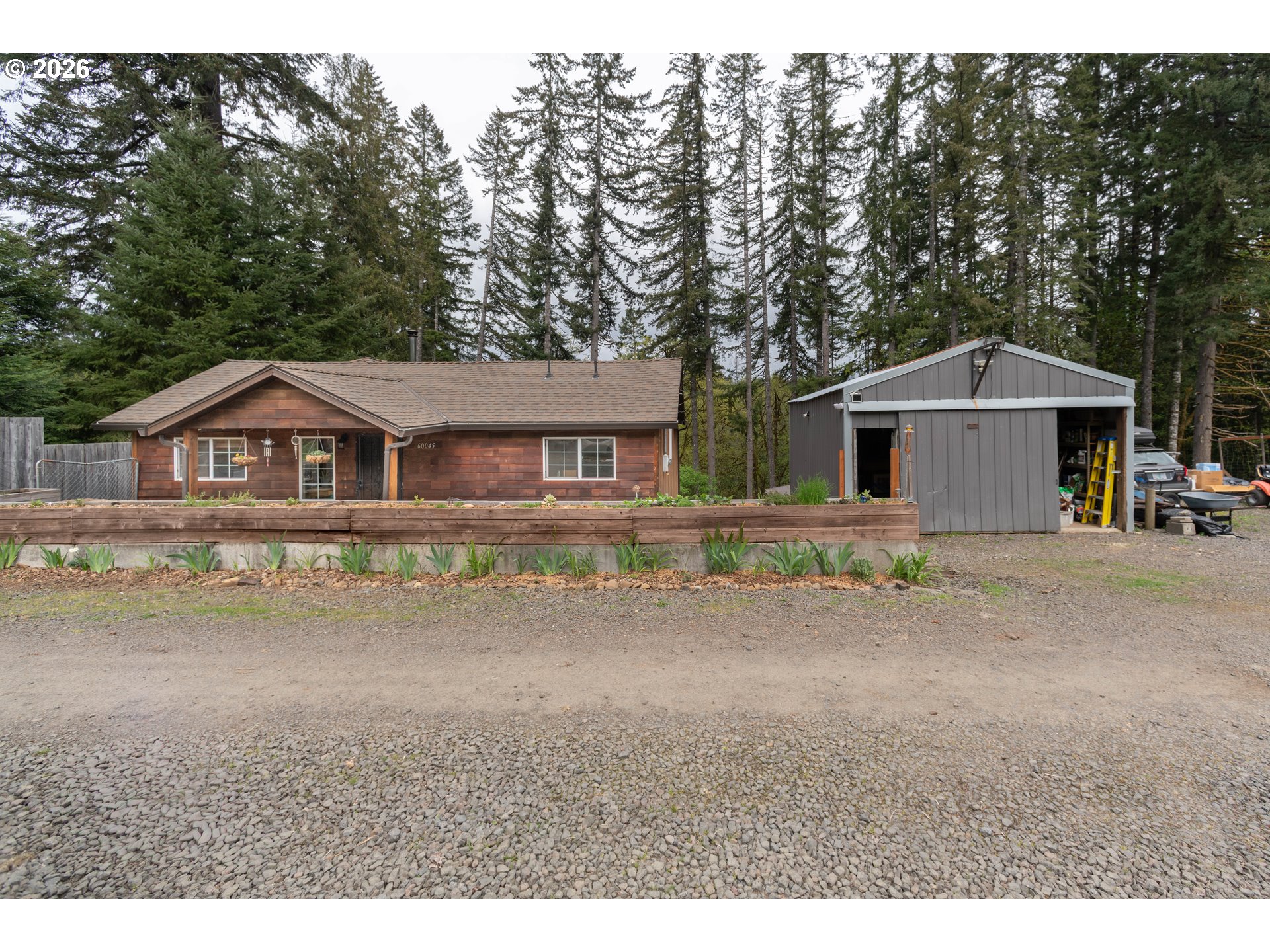 60045 Northwest Railroad Avenue Timber, OR 97144 - Photo 34 of 41 a front view of a house with a yard and garage