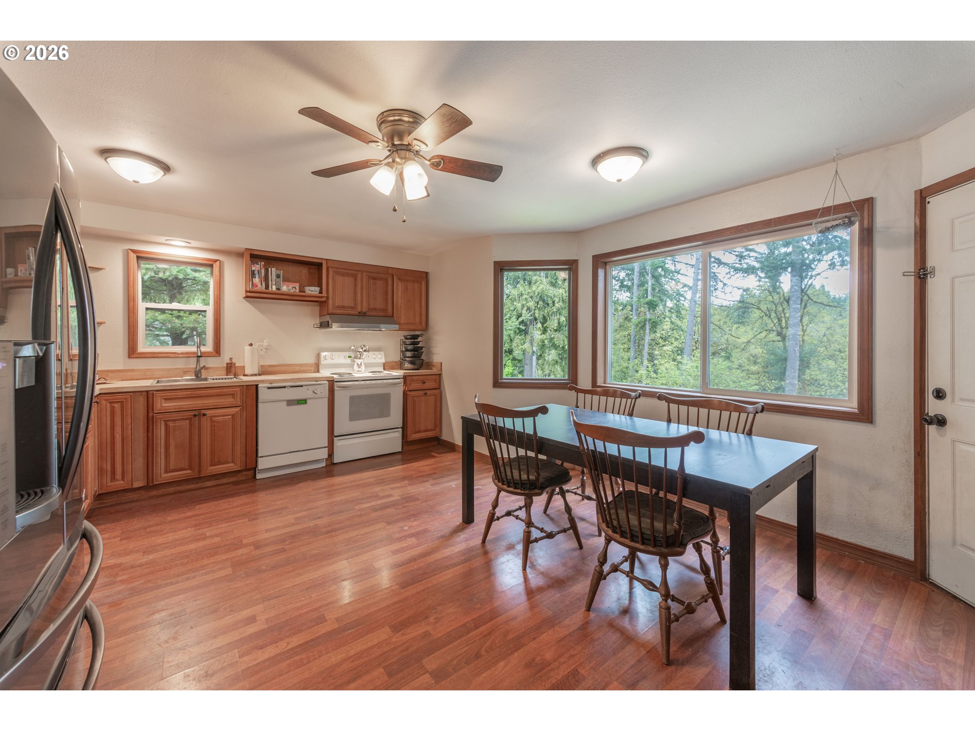 60045 Northwest Railroad Avenue Timber, OR 97144 - Photo 10 of 41 a open kitchen with a table chairs a sink dishwasher and cabinets with wooden floor