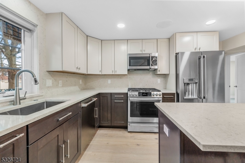 147 Chestnut Street Bridgewater, NJ 08807 - Photo 4 of 13 a kitchen with stainless steel appliances granite countertop a sink stove and refrigerator