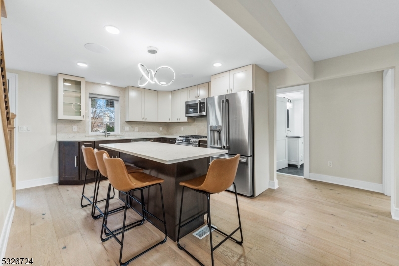 147 Chestnut Street Bridgewater, NJ 08807 - Photo 5 of 13 a kitchen with stainless steel appliances granite countertop a refrigerator and a stove top oven