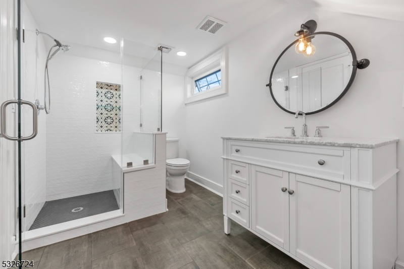 147 Chestnut Street Bridgewater, NJ 08807 - Photo 7 of 13 a bathroom with a toilet a sink and mirror