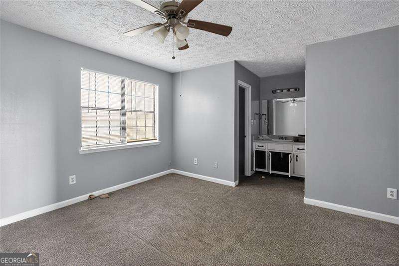 5957 Friar Court, Unit A Atlanta, GA 30349 - Photo 13 of 16 an empty room with windows