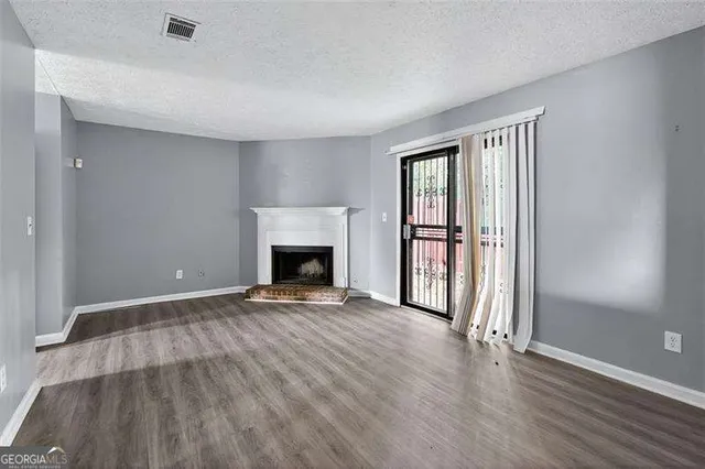 wooden floor fireplace and natural light in room