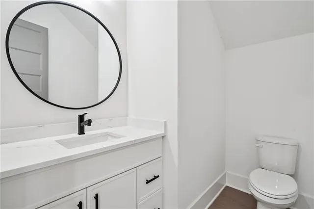 a bathroom with a sink a toilet and a mirror