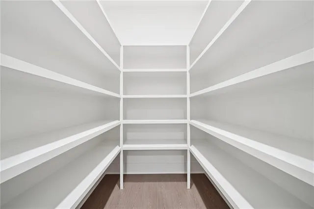 a view of walk in closet with empty racks