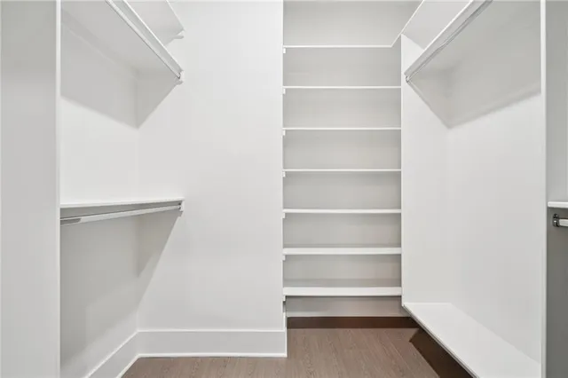 a view of walk in closet with empty racks
