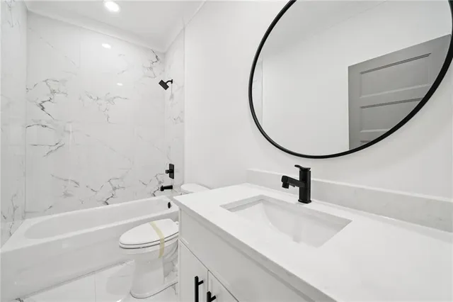 a bathroom with a sink a toilet and a mirror