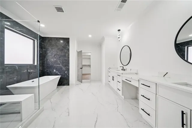 a spacious bathroom with a double vanity sink mirror and a bathtub
