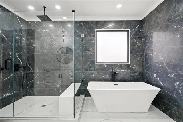 a bathroom with a bathtub and shower