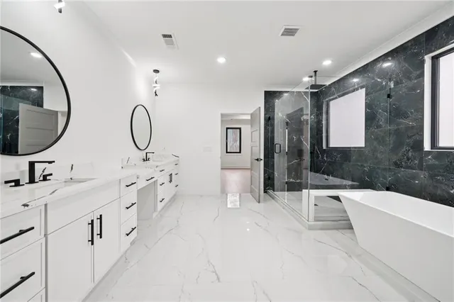 a spacious bathroom with a double vanity sink a mirror and a shower