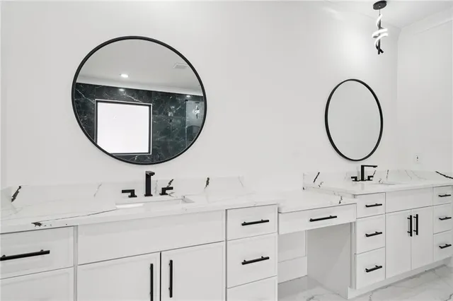 a bathroom with a sink a double vanity and a mirror