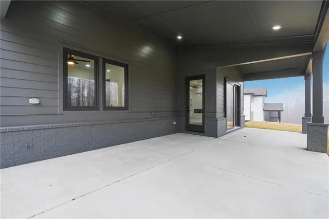 a view of an empty room with a fireplace and a window