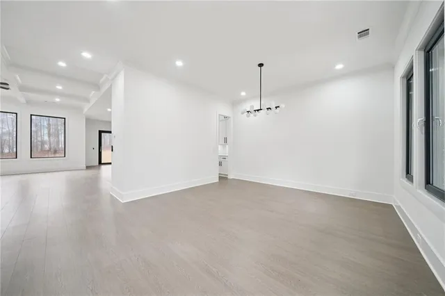 an empty room with a empty space and windows