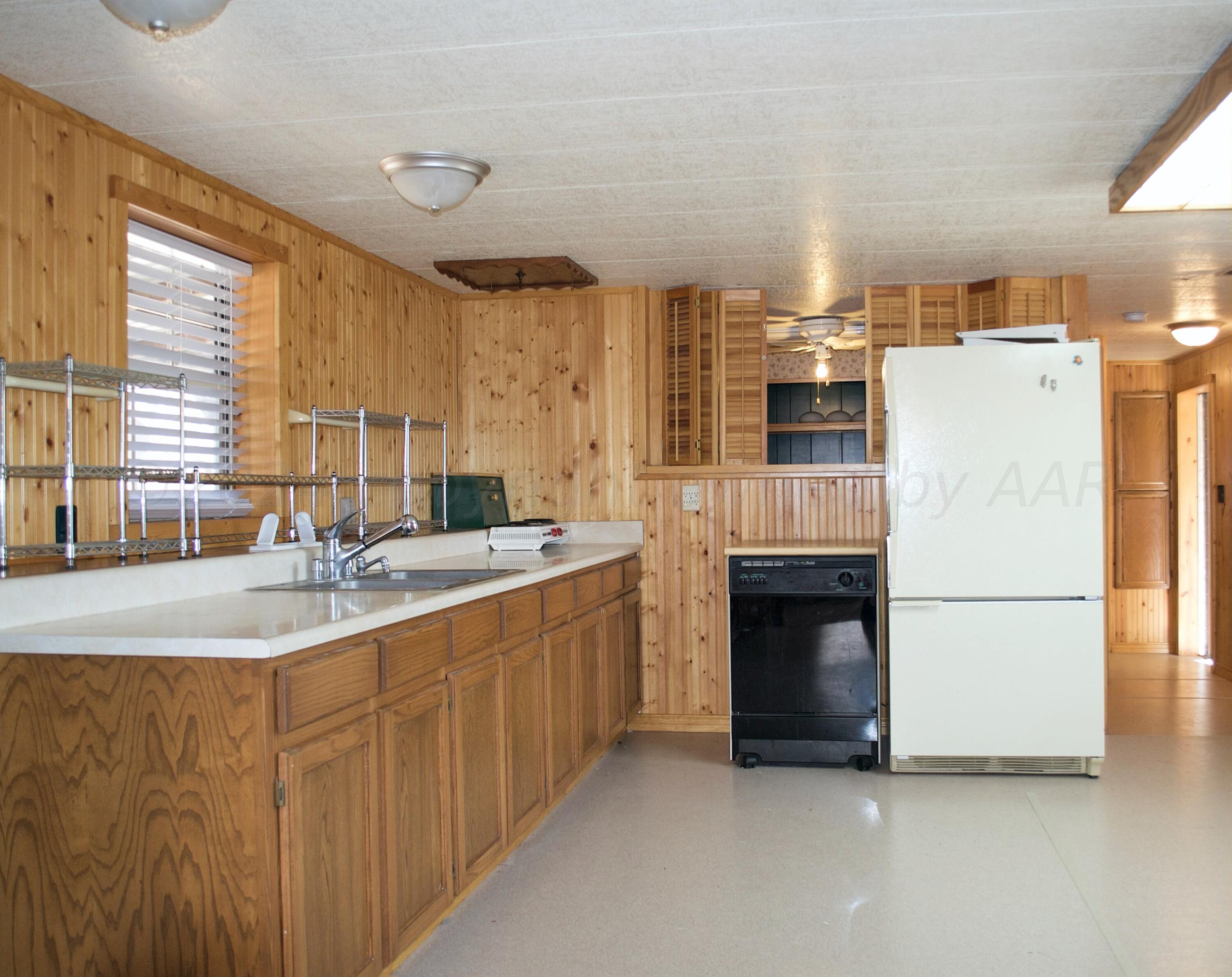 531 West Studebaker Avenue Amarillo, TX 79108 - Photo 11 of 25 a kitchen with refrigerator and cabinets