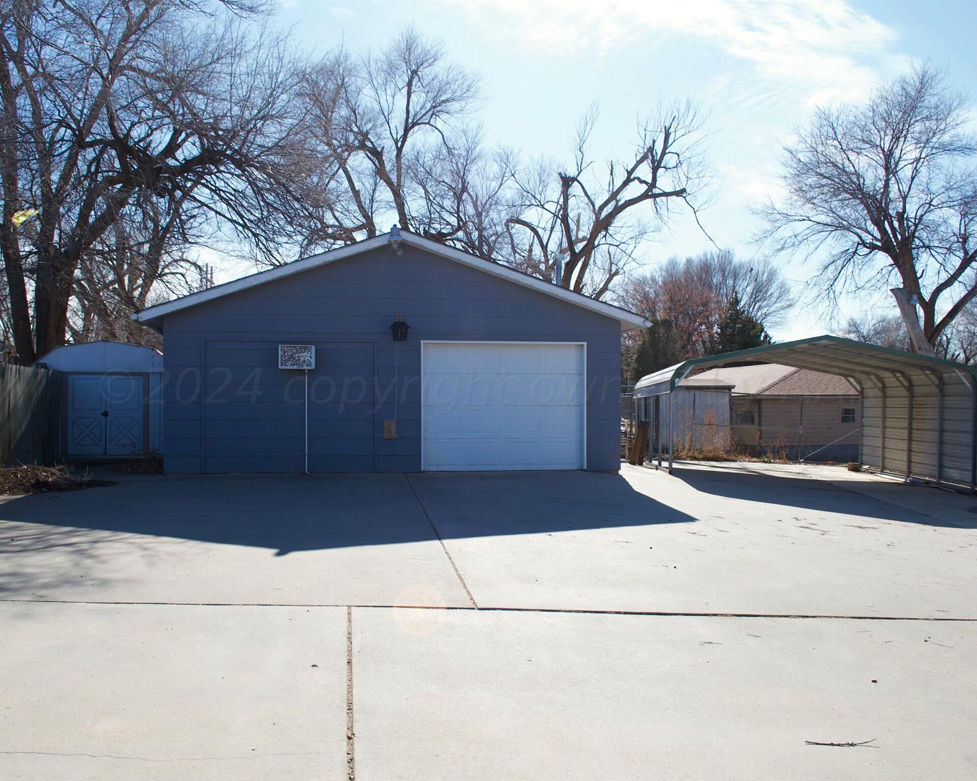 531 West Studebaker Avenue Amarillo, TX 79108 - Photo 5 of 25 a front view of a house with a yard and garage