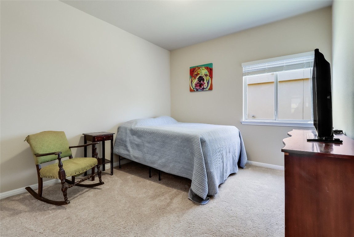1425 Hamiltons Way Leander, TX 78641 - Photo 11 of 38 a bedroom with a bed and a chair in it