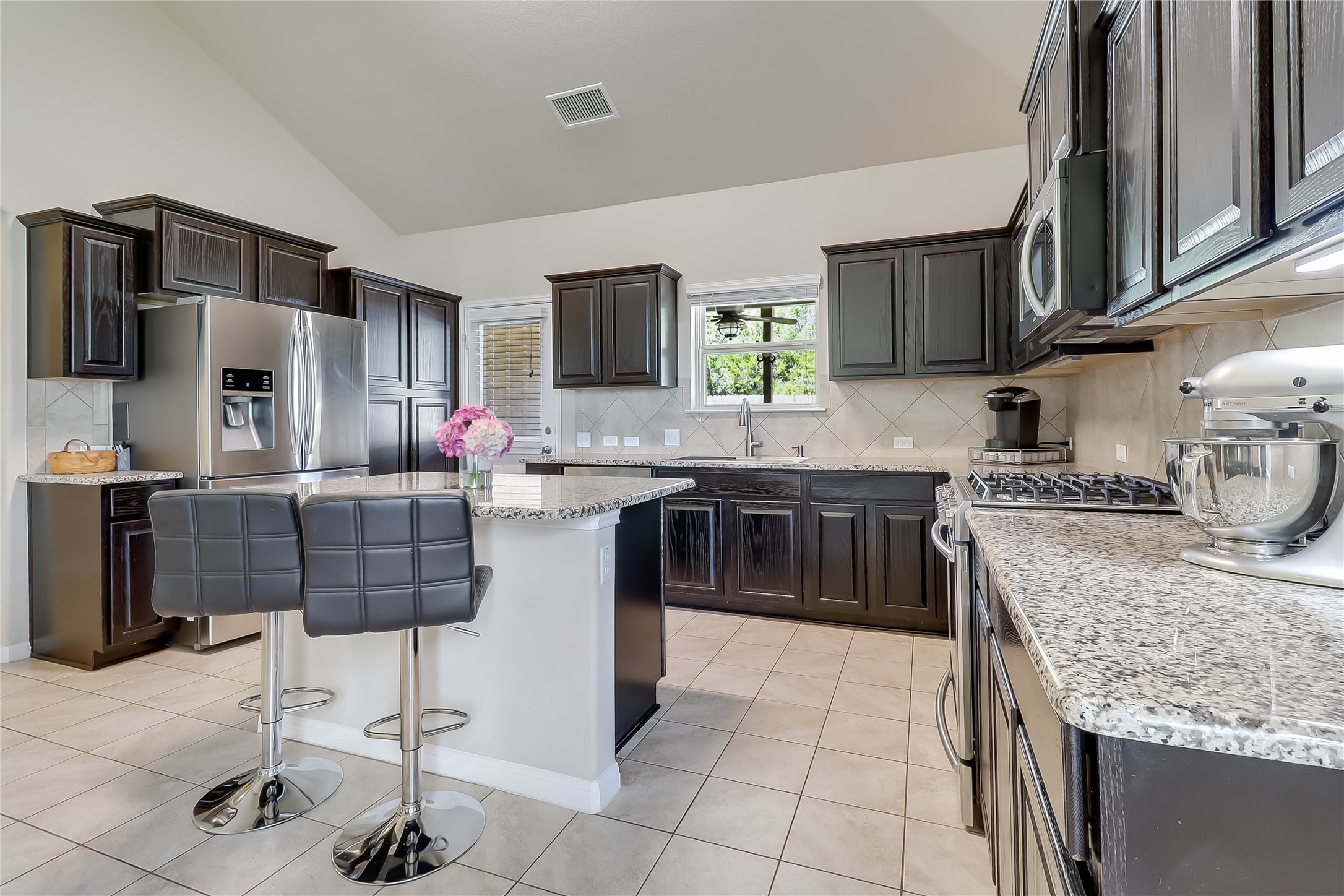 1425 Hamiltons Way Leander, TX 78641 - Photo 16 of 38 a kitchen with stainless steel appliances granite countertop a stove top oven a sink dishwasher and cabinets